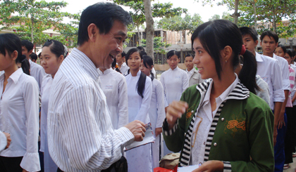 TS-BS Nguyễn Xuân Trang tặng quà cho học sinh Trường THPT Lưu Tấn Phát, huyện Cai Lậy.